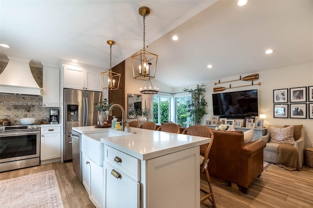 13765 SW 147th Cir Ln Unit 2-24, Miami, FL 33186 - kitchen with stainless steel appliances, custom range hood, open floor plan, decorative backsplash, and lofted ceiling