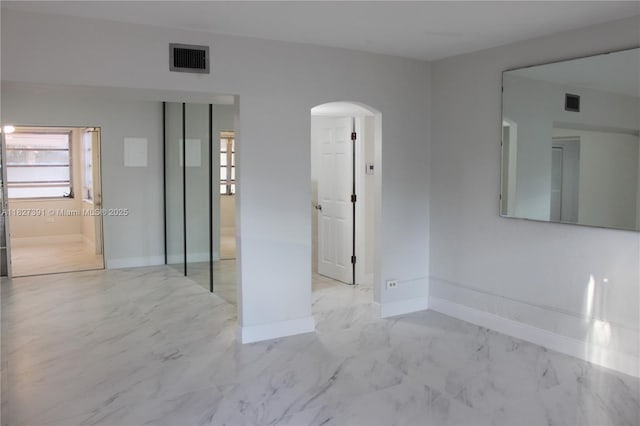971 E 18th St, Hialeah, FL 33013 - empty room with arched walkways and marble look tiles