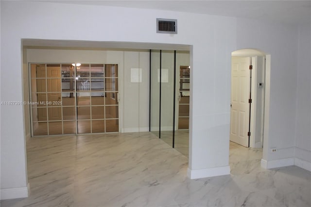 971 E 18th St, Hialeah, FL 33013 - spare room featuring arched walkways and marble finish flooring
