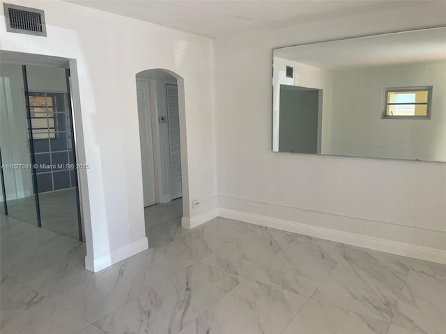 971 E 18th St, Hialeah, FL 33013 - empty room featuring arched walkways and marble look tiles