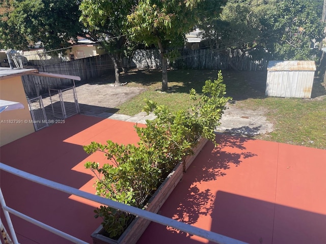 971 E 18th St, Hialeah, FL 33013 - fenced backyard with a patio area and a storage unit
