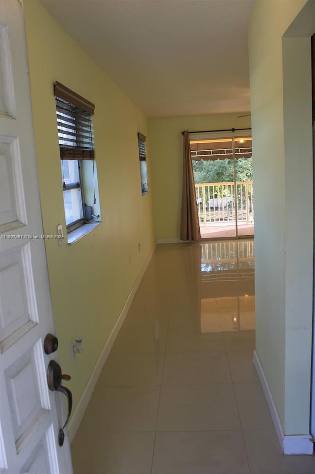 971 E 18th St, Hialeah, FL 33013 - hallway featuring light tile patterned flooring and baseboards