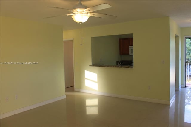 971 E 18th St, Hialeah, FL 33013 - empty room featuring plenty of natural light, a ceiling fan, and light tile patterned floors