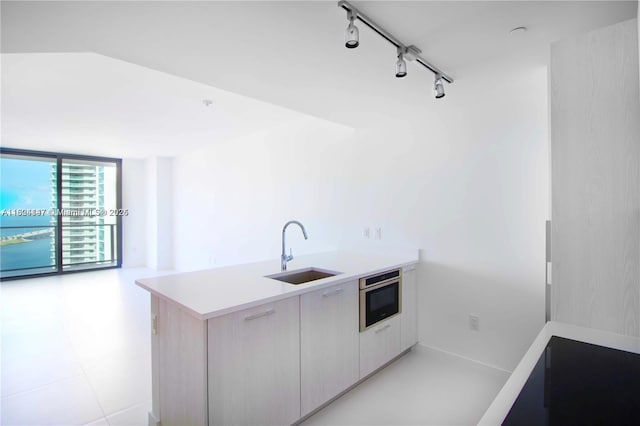 501 NE 31st St Unit 2005, Miami, FL 33137 - kitchen with track lighting, light countertops, modern cabinets, a peninsula, and expansive windows