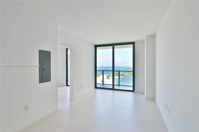 501 NE 31st St Unit 2005, Miami, FL 33137 - spare room featuring electric panel, a wall of windows, and light tile patterned flooring