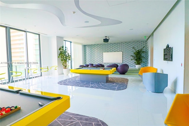 501 NE 31st St Unit 2005, Miami, FL 33137 - playroom featuring billiards table, an accent wall, a wall of windows, and tile patterned flooring