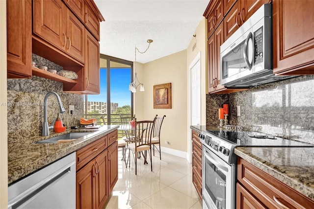 7400 Radice Ct Unit 508, Lauderhill, FL 33319 - kitchen with stainless steel appliances, tasteful backsplash, stone counters, and a textured ceiling