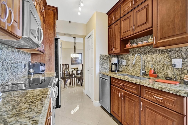 7400 Radice Ct Unit 508, Lauderhill, FL 33319 - kitchen featuring appliances with stainless steel finishes, light stone countertops, tasteful backsplash, light tile patterned floors, and brown cabinets
