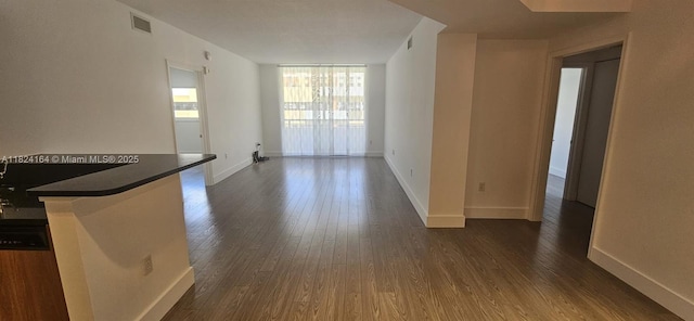 2775 NE 187th St Unit 424, Aventura, FL 33180 - unfurnished living room with dark wood-style floors and baseboards