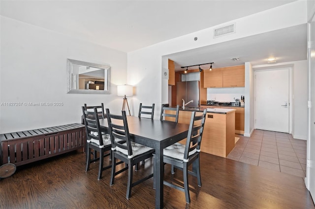 50 Biscayne Blvd Unit 3605, Miami, FL 33132 - dining room featuring radiator, wood finished floors, and rail lighting
