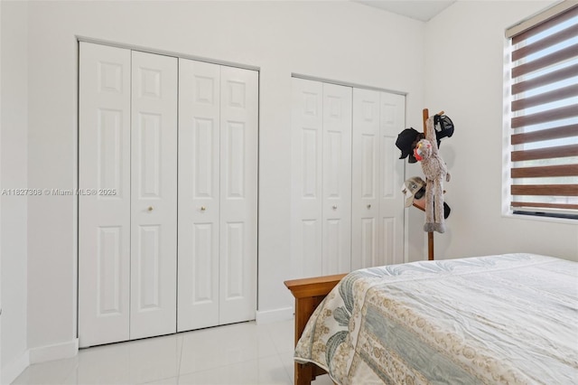 9349 W 33rd Way, Hialeah, FL 33018 - bedroom featuring multiple windows, two closets, and light tile patterned floors