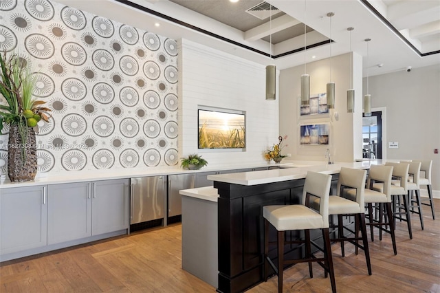 9349 W 33rd Way, Hialeah, FL 33018 - bar featuring light wood-type flooring, fridge, and decorative light fixtures