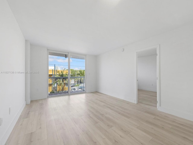 401 Ocean Dr Unit 403, Miami Beach, FL 33139 - unfurnished room with light wood-type flooring and floor to ceiling windows