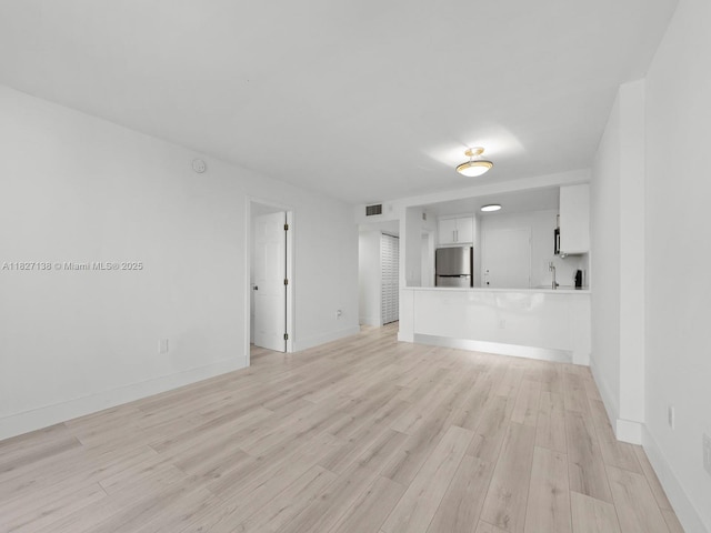 401 Ocean Dr Unit 403, Miami Beach, FL 33139 - unfurnished living room featuring light wood finished floors and baseboards