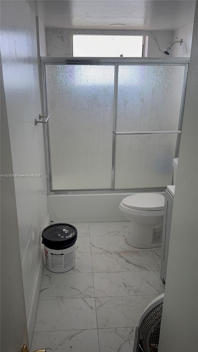 1750 NE 191st St Unit 804-1, Miami, FL 33179 - full bathroom with marble look tiles, healthy amount of natural light, shower / bath combination with glass door, and vanity