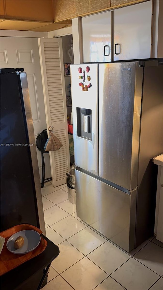1750 NE 191st St Unit 804-1, Miami, FL 33179 - kitchen featuring stainless steel refrigerator with ice dispenser, freestanding refrigerator, and light tile patterned floors