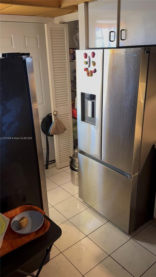 1750 NE 191st St Unit 804-1, Miami, FL 33179 - kitchen with stainless steel refrigerator with ice dispenser, freestanding refrigerator, and light tile patterned floors