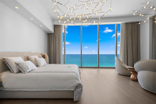 17901 Collins Ave Unit 1607, Sunny Isles Beach, FL 33160 - bedroom featuring expansive windows, a water view, wood finished floors, and recessed lighting