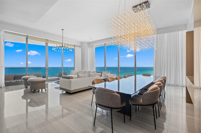 17901 Collins Ave Unit 1607, Sunny Isles Beach, FL 33160 - dining room featuring a chandelier, a wall of windows, and a water view