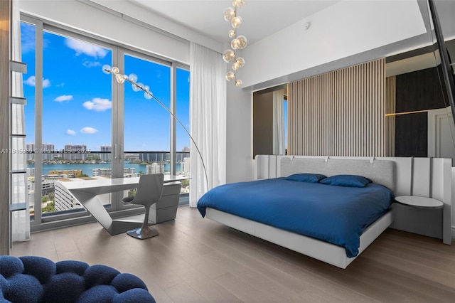 17901 Collins Ave Unit 1607, Sunny Isles Beach, FL 33160 - bedroom with wood finished floors, a water view, and expansive windows
