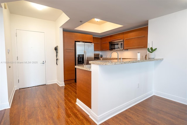 2641 N Flamingo Rd Unit 1603N, Sunrise, FL 33323 - kitchen featuring brown cabinets, stainless steel appliances, a peninsula, dark wood-type flooring, and modern cabinets