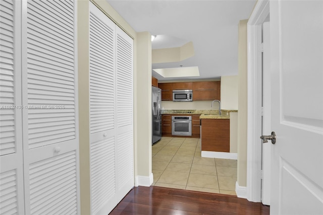 2681 N Flamingo Rd Unit 1903S, Sunrise, FL 33323 - kitchen featuring appliances with stainless steel finishes, brown cabinetry, and light wood finished floors