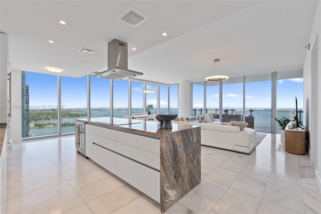 700 NE 26th Ter Unit 3101, Miami, FL 33137 - living area featuring a wall of windows, a water view, wine cooler, and recessed lighting