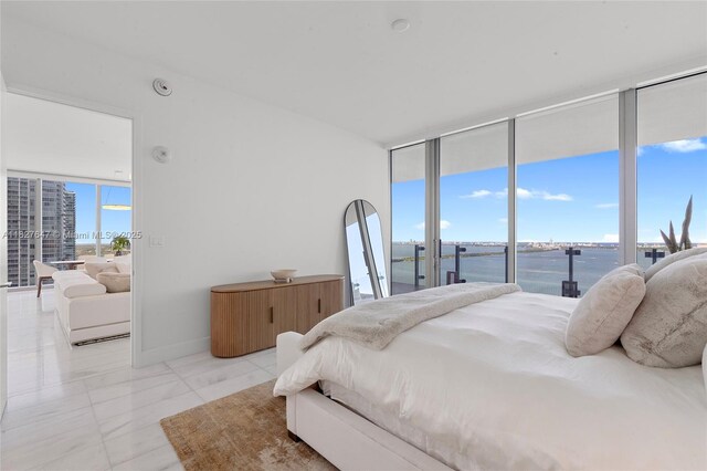 700 NE 26th Ter Unit 3101, Miami, FL 33137 - bedroom with access to outside, a water view, and a wall of windows