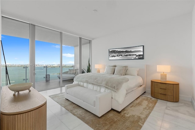 700 NE 26th Ter Unit 3101, Miami, FL 33137 - bedroom with light marble finish flooring, access to exterior, a wall of windows, and a water view