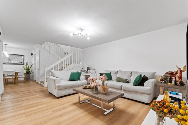 806 SW 119th Way, Davie, FL 33325 - living area featuring light wood-type flooring, stairway, and a chandelier