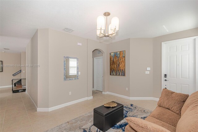 11029 NW 87th St, Doral, FL 33178 - living room featuring arched walkways, light tile patterned floors, and a chandelier