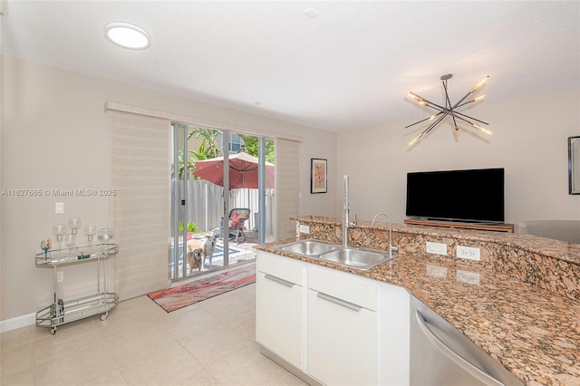 11029 NW 87th St, Doral, FL 33178 - kitchen with stainless steel dishwasher, a chandelier, white cabinets, light stone countertops, and open floor plan
