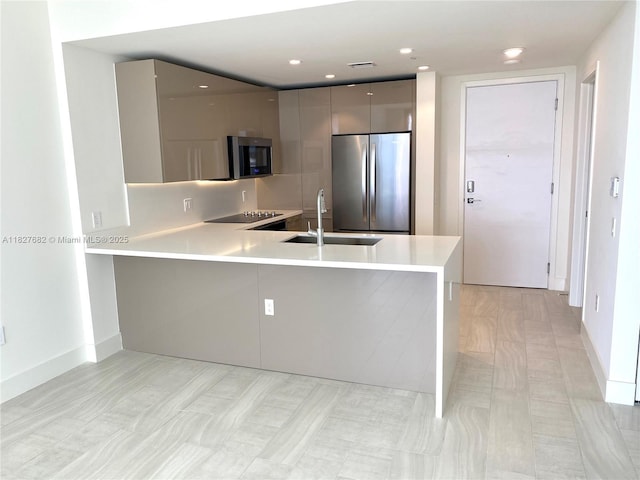 2000 Metropica Way Unit 1605, Sunrise, FL 33323 - kitchen with appliances with stainless steel finishes, modern cabinets, light countertops, a peninsula, and gray cabinets