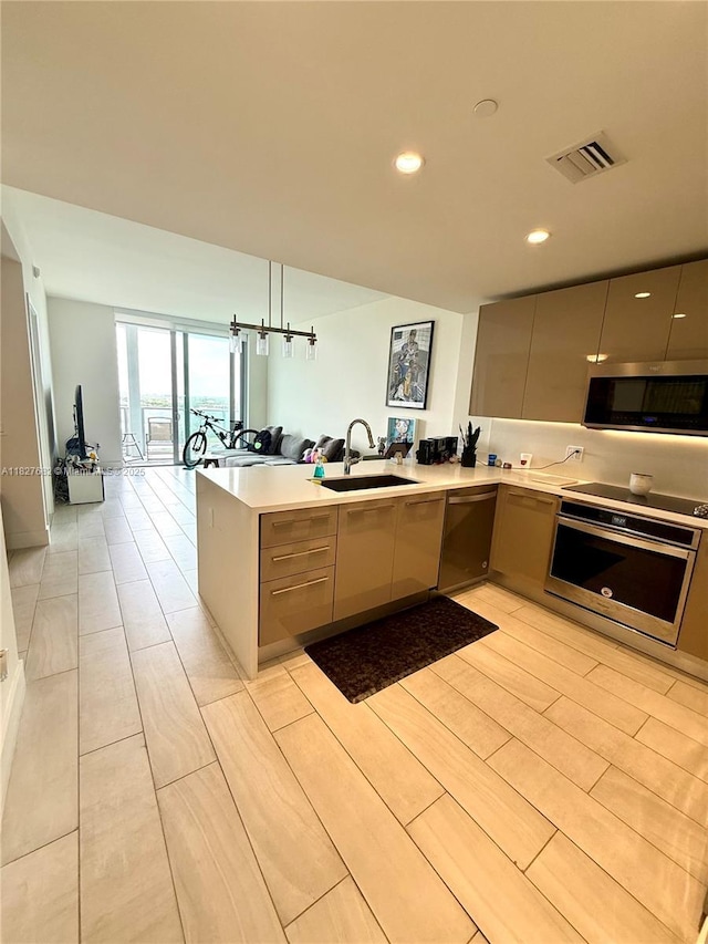 2000 Metropica Way Unit 1605, Sunrise, FL 33323 - kitchen featuring stainless steel appliances, modern cabinets, a peninsula, open floor plan, and light countertops