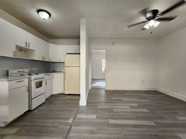 3615 Thomas Ave Unit 1, Miami, FL 33133 - kitchen featuring white appliances, a ceiling fan, a textured ceiling, white cabinets, and wood finished floors