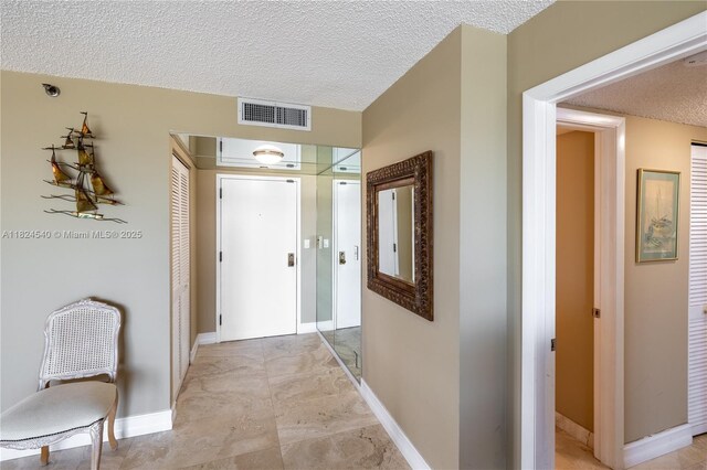 2000 Towerside Ter Unit 1112, Miami, FL 33138 - corridor with a textured ceiling and baseboards