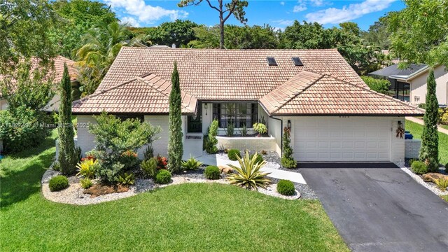 8525 NW 49th Dr, Coral Springs, FL 33067 - view of front facade with a tile roof, brick siding, a front yard, and asphalt driveway