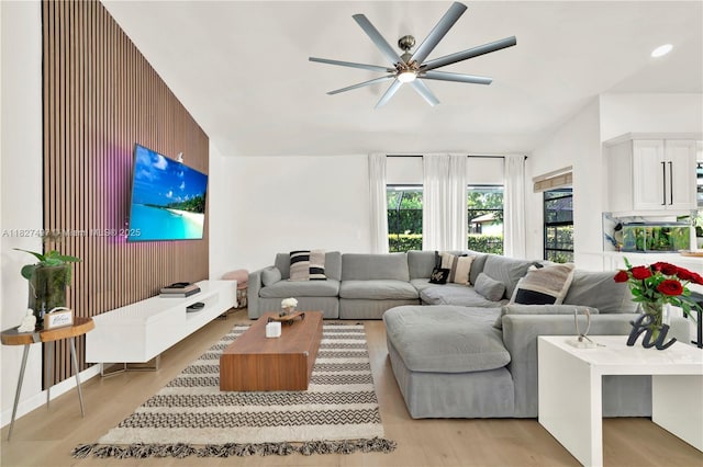 8525 NW 49th Dr, Coral Springs, FL 33067 - living room featuring a ceiling fan, light wood finished floors, and wood walls