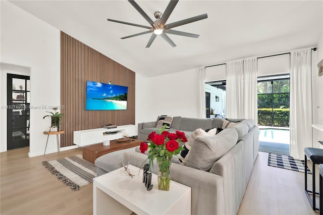 8525 NW 49th Dr, Coral Springs, FL 33067 - living room with ceiling fan, high vaulted ceiling, light wood finished floors, and wooden walls