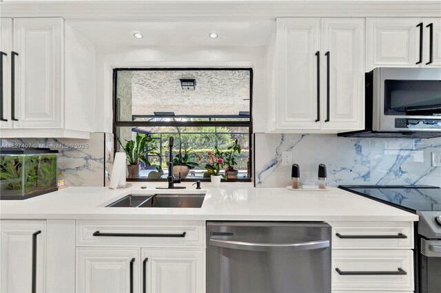 8525 NW 49th Dr, Coral Springs, FL 33067 - kitchen with appliances with stainless steel finishes, tasteful backsplash, white cabinetry, and recessed lighting