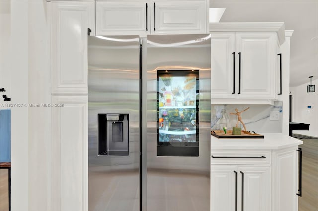 8525 NW 49th Dr, Coral Springs, FL 33067 - kitchen with stainless steel refrigerator with ice dispenser, white cabinets, and light countertops
