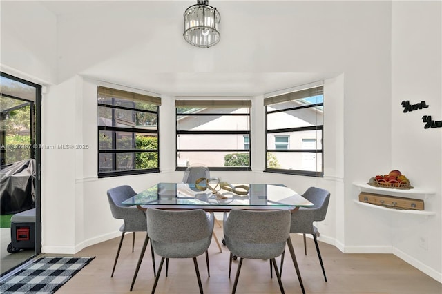 8525 NW 49th Dr, Coral Springs, FL 33067 - dining room with wood finished floors and healthy amount of natural light