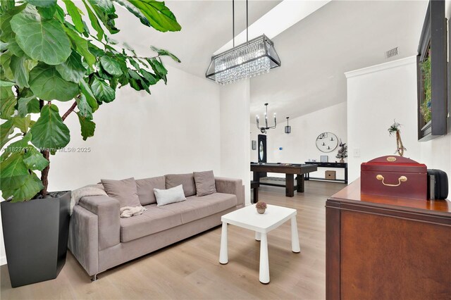 8525 NW 49th Dr, Coral Springs, FL 33067 - living room featuring a chandelier, light wood finished floors, and lofted ceiling