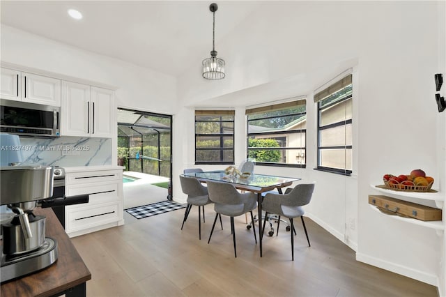 8525 NW 49th Dr, Coral Springs, FL 33067 - dining room with healthy amount of natural light, light wood finished floors, a chandelier, recessed lighting, and high vaulted ceiling