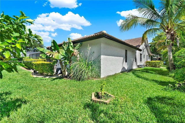 8525 NW 49th Dr, Coral Springs, FL 33067 - view of side of home featuring stucco siding, a lawn, and a tiled roof