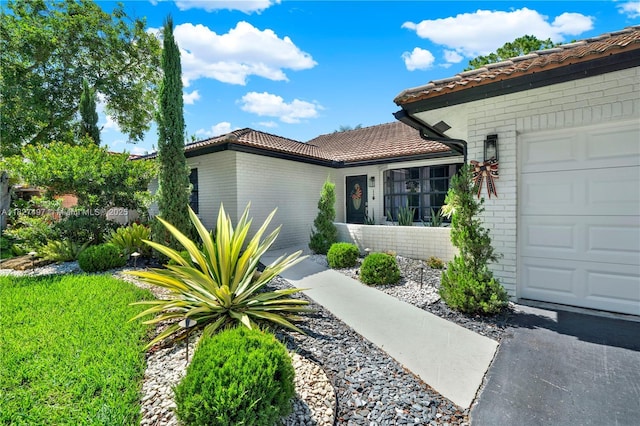 8525 NW 49th Dr, Coral Springs, FL 33067 - view of front of house featuring brick siding, a tiled roof, and a garage