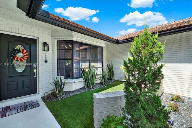 8525 NW 49th Dr, Coral Springs, FL 33067 - doorway to property featuring brick siding and a tile roof
