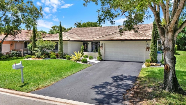 8525 NW 49th Dr, Coral Springs, FL 33067 - ranch-style house featuring a tile roof, an attached garage, asphalt driveway, brick siding, and a front lawn