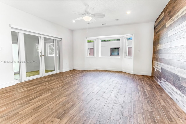 5881 SW 160th Ave, Southwest Ranches, FL 33331 - spare room featuring light wood-type flooring, ceiling fan, wooden walls, french doors, and recessed lighting