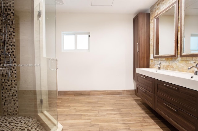 5881 SW 160th Ave, Southwest Ranches, FL 33331 - bathroom with double vanity, a shower stall, tasteful backsplash, and wood finished floors